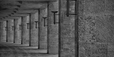 curved stone walkway lit by lamps