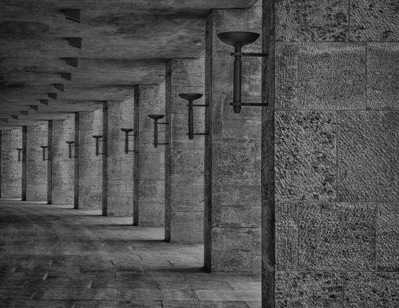 curved stone walkway lit by lamps