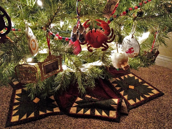Christmas tree skirt and low-hanging ornaments