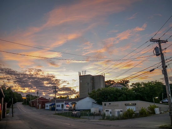 Local businesses and warehouses in downtown Waterville at sunset.