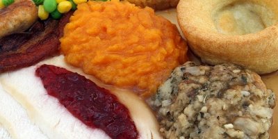 A full plate of Thanksgiving favorites, featuring a helping of cranberry sauce
