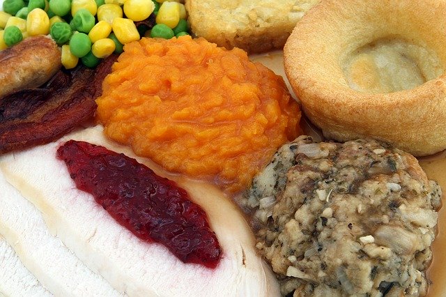 A full plate of Thanksgiving favorites, featuring a helping of cranberry sauce