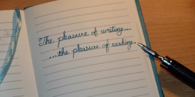 a journal with handwriting it in and an old pen