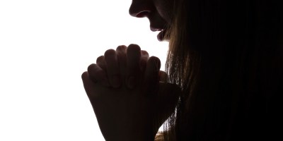 Young woman looking down, profile of a silhouette