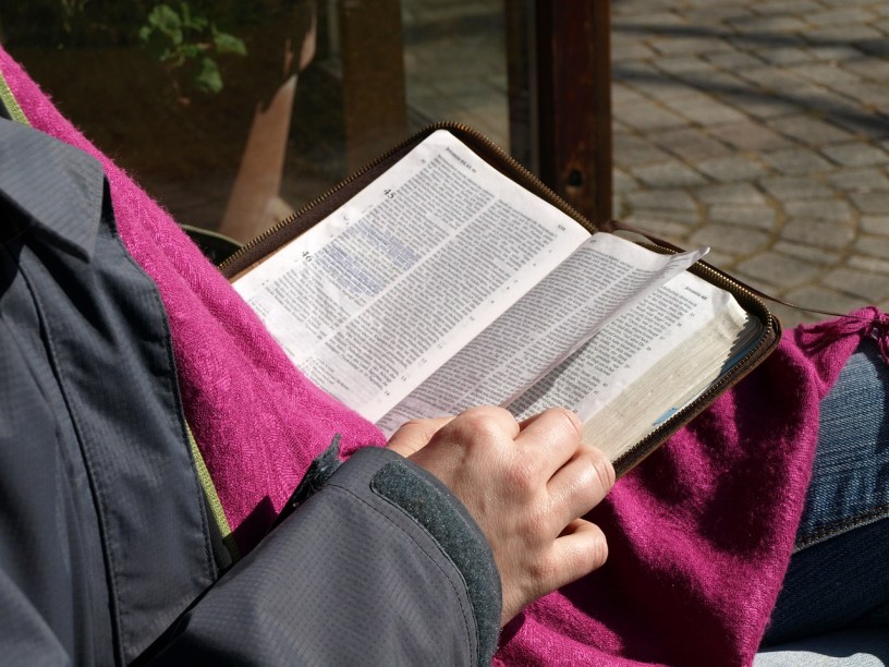 scriptures in a person's lap as they read and study