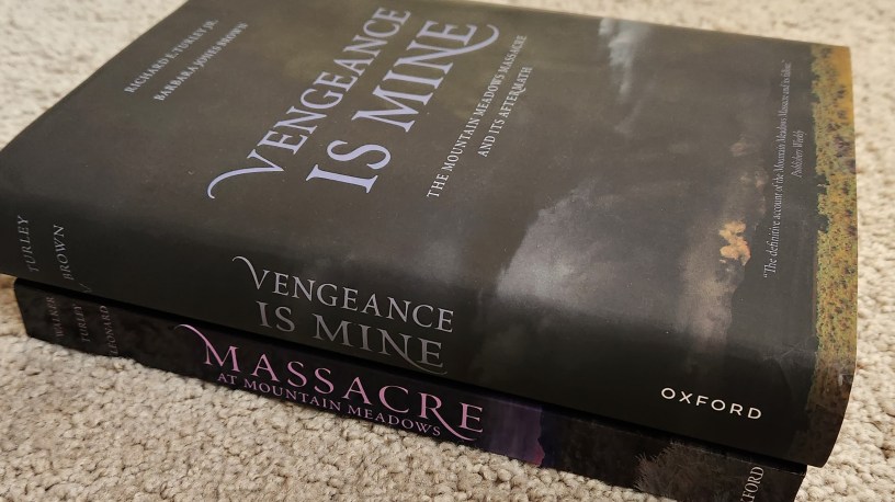 Photograph of two books. One is titled Massacre at Mountain Meadows. The other is titled Vengeance is Mine.