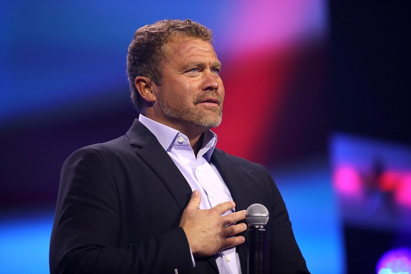 Tim Ballard standing with a microphone.