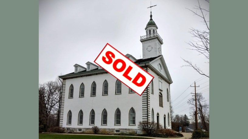 the Kirtland Temple, sacred site of Mormonism, on a cloudy day, marked with a "SOLD" stamp