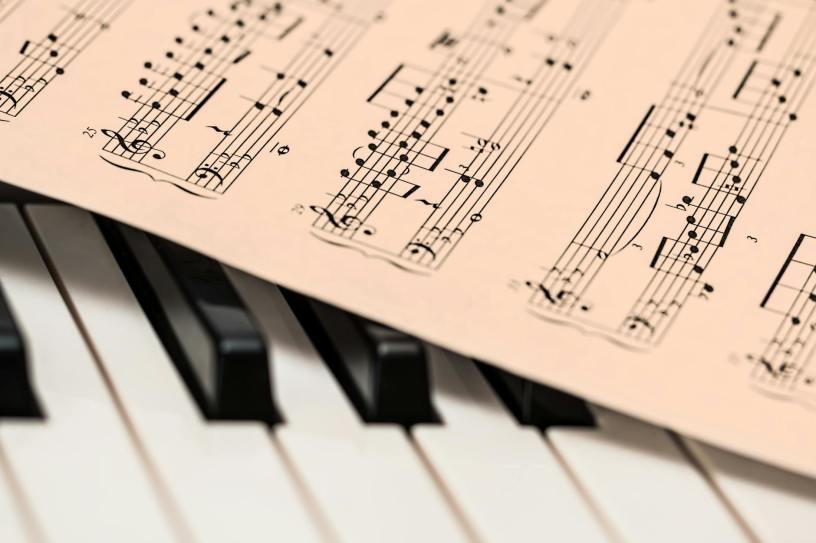 sheet music resting on top of piano keys
