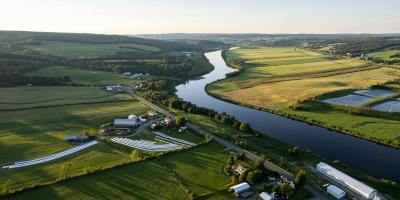 A river meanders through a rural community