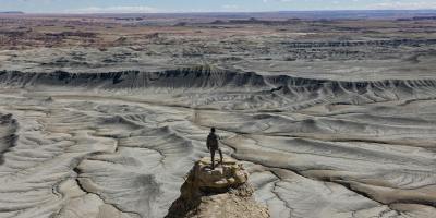 a man in the Utah desert on a pinnacle