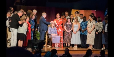 Stassi Cramm (seated) ordained by emeritus president Steven Veazey & Q12 Pres Mareva Arnaud Tchong.