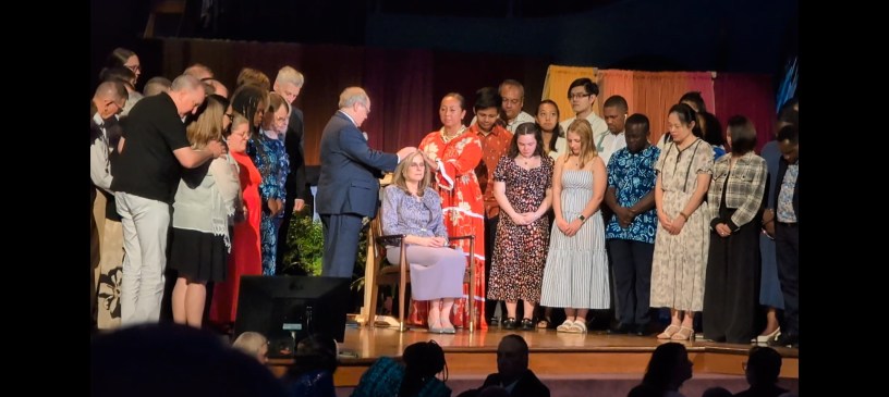 Stassi Cramm (seated) ordained by emeritus president Steven Veazey & Q12 Pres Mareva Arnaud Tchong.