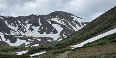 grays peak, a Colorado 14er mountain, as seen from the glacial valley below, as rain clouds roll in from beyond the summit