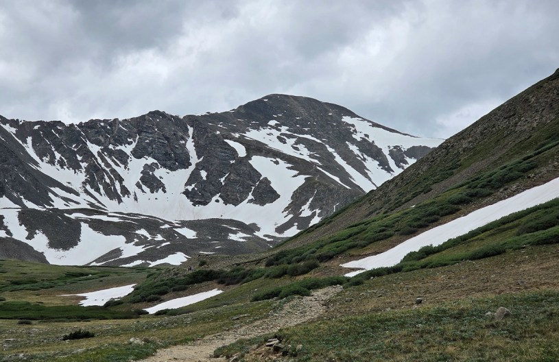 grays peak, a Colorado 14er mountain, as seen from the glacial valley below, as rain clouds roll in from beyond the summit